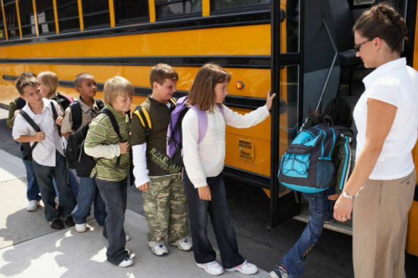 スクールバスに乗り込む小学生たち（写真:アフロ）