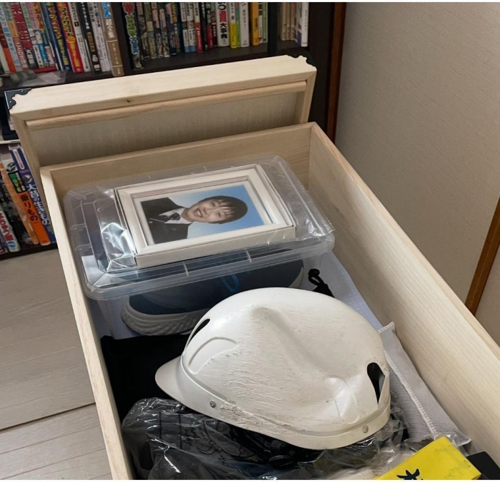 時間をかけて綺麗に洗われ、復元された晴琉くんの遺品は、桐箱に収められていた。事故時にかぶっていたヘルメットは激しく損傷している(筆者撮影)